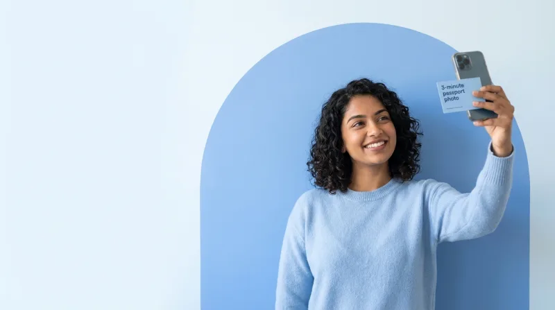 Person taking a selfie for a passport photo at home